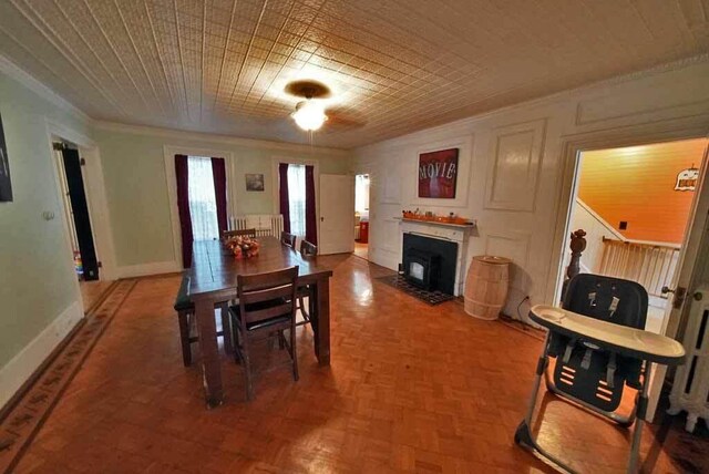 84 Military St, Houlton, ME 04730 - dining space featuring ornamental molding, a fireplace with flush hearth, and baseboards
