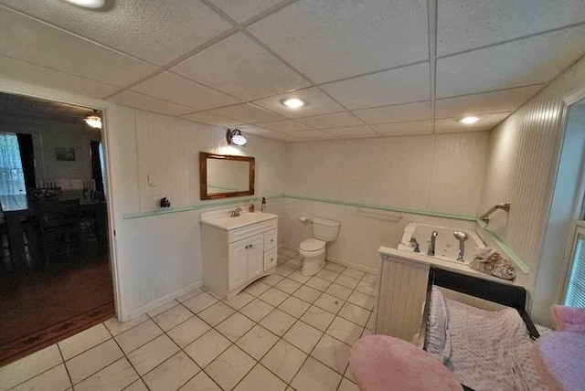 84 Military St, Houlton, ME 04730 - bathroom with tile patterned flooring, vanity, toilet, and a drop ceiling