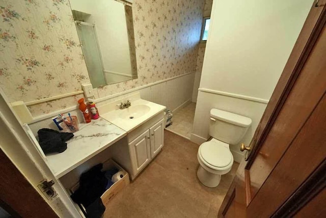 84 Military St, Houlton, ME 04730 - full bathroom with wallpapered walls, wainscoting, toilet, vanity, and a shower