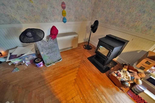 84 Military St, Houlton, ME 04730 - misc room featuring wallpapered walls, wainscoting, and a wood stove