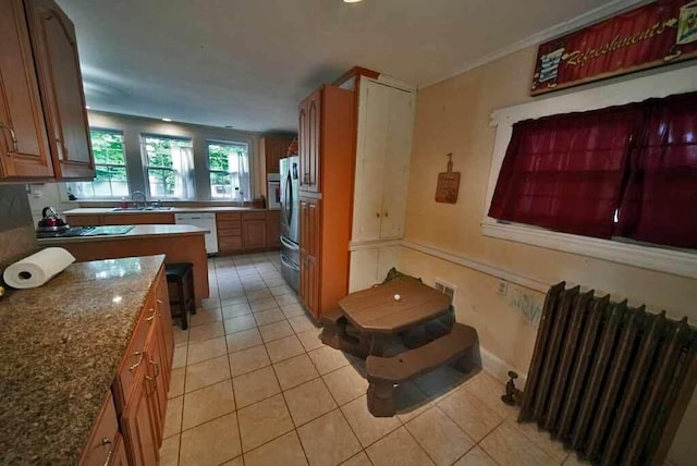 84 Military St, Houlton, ME 04730 - kitchen featuring radiator heating unit, a sink, light tile patterned floors, dishwasher, and freestanding refrigerator