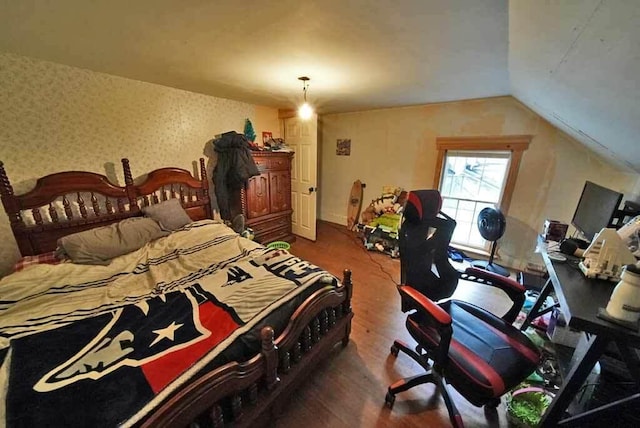 84 Military St, Houlton, ME 04730 - bedroom with wood finished floors, wallpapered walls, and lofted ceiling