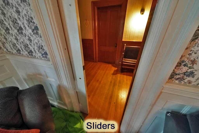 84 Military St, Houlton, ME 04730 - detailed view of wainscoting, wallpapered walls, and wood finished floors