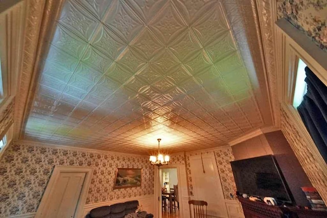 84 Military St, Houlton, ME 04730 - living area with a chandelier, ornamental molding, and an ornate ceiling
