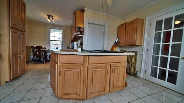 84 Military St, Houlton, ME 04730 - kitchen with light tile patterned flooring, black gas cooktop, crown molding, a kitchen island, and light countertops