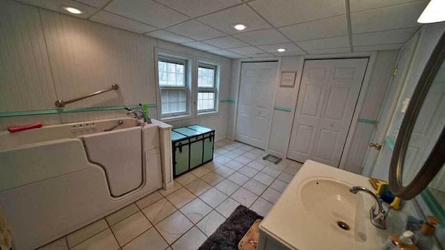 84 Military St, Houlton, ME 04730 - full bathroom featuring a bath, tile patterned flooring, a drop ceiling, and vanity