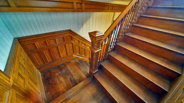 84 Military St, Houlton, ME 04730 - staircase with wood walls and wood-type flooring