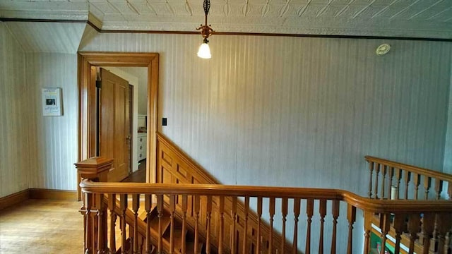 84 Military St, Houlton, ME 04730 - hall featuring an upstairs landing, wood finished floors, crown molding, baseboards, and wallpapered walls