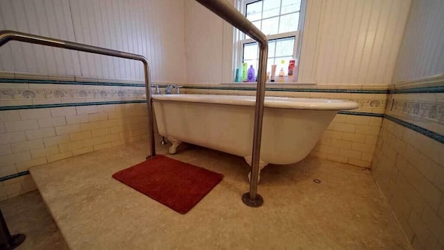 84 Military St, Houlton, ME 04730 - full bathroom with tile walls, a freestanding tub, and wainscoting
