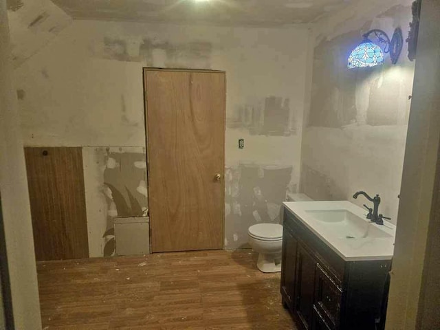 84 Military St, Houlton, ME 04730 - bathroom with toilet, wood finished floors, and vanity