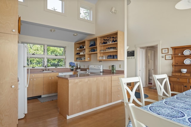 223 Pemaquid Trl, Bristol, ME 04554 - kitchen with a sink, a towering ceiling, white appliances, light wood-type flooring, and open shelves