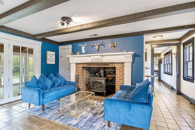 tiled living room with a wood stove, beam ceiling, visible vents, and baseboards