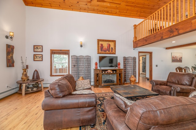 575 Hallowell Rd, Chelsea, ME 04330 - living area featuring high vaulted ceiling, light wood-style floors, wood ceiling, and a baseboard heating unit