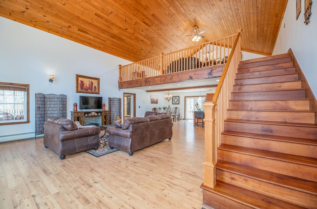 575 Hallowell Rd, Chelsea, ME 04330 - living room with high vaulted ceiling, stairs, a ceiling fan, wooden ceiling, and baseboard heating