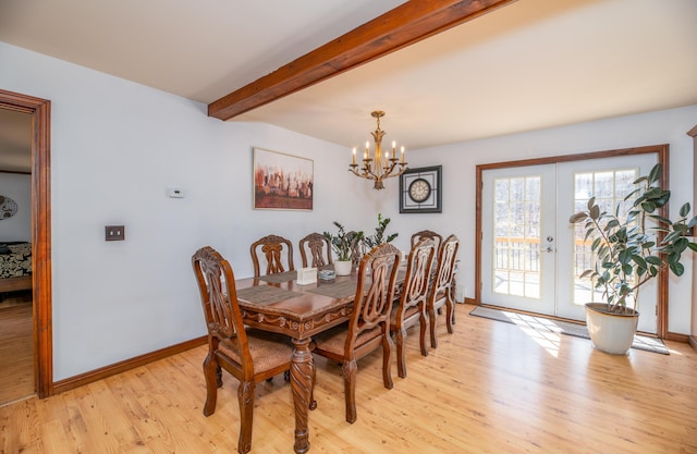 575 Hallowell Rd, Chelsea, ME 04330 - dining space featuring light wood-style floors, french doors, a chandelier, beam ceiling, and baseboards