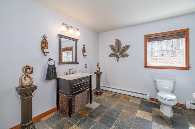 575 Hallowell Rd, Chelsea, ME 04330 - bathroom with baseboard heating, stone tile floors, baseboards, and toilet