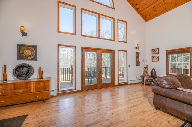 575 Hallowell Rd, Chelsea, ME 04330 - living room with high vaulted ceiling, a baseboard radiator, french doors, a baseboard heating unit, and light wood finished floors