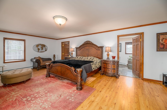 575 Hallowell Rd, Chelsea, ME 04330 - bedroom featuring light wood-style floors, crown molding, baseboards, ensuite bathroom, and a baseboard radiator