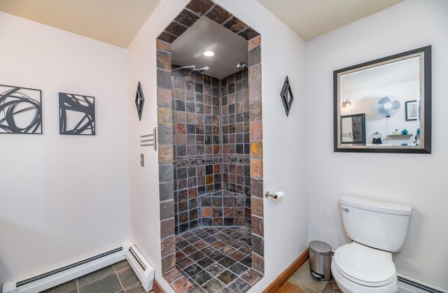 575 Hallowell Rd, Chelsea, ME 04330 - bathroom featuring a baseboard heating unit, toilet, a tile shower, and baseboards