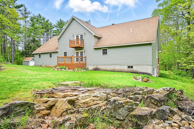 575 Hallowell Rd, Chelsea, ME 04330 - back of property with a balcony, french doors, a shingled roof, and a lawn