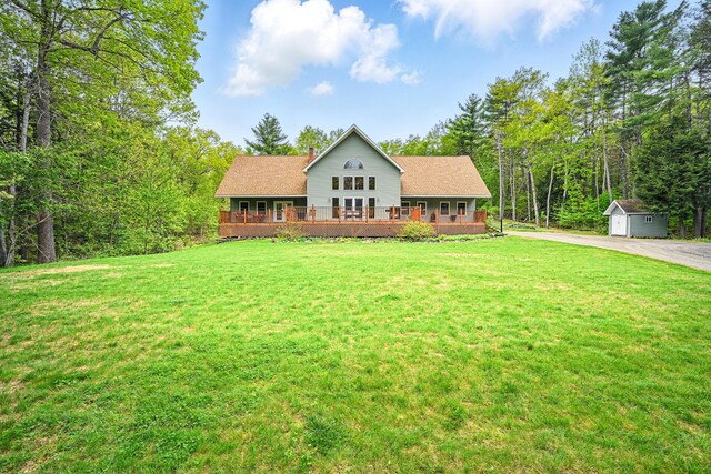 575 Hallowell Rd, Chelsea, ME 04330 - view of front of home featuring a front yard, a chimney, a deck, driveway, and a shingled roof