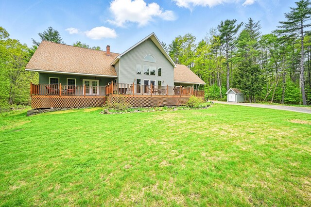 575 Hallowell Rd, Chelsea, ME 04330 - back of house featuring a lawn, a chimney, a wooden deck, driveway, and a shingled roof