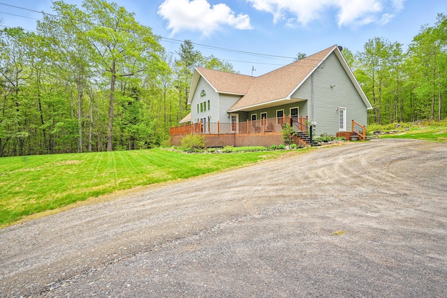 575 Hallowell Rd, Chelsea, ME 04330 - view of side of home with driveway, a wooden deck, a shingled roof, and a yard