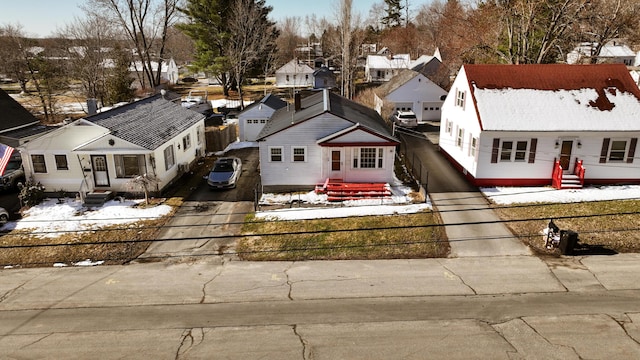 snowy aerial view with a residential view