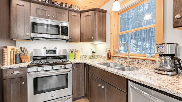 18 Lovers Ln, Bethel, ME 04217 - kitchen featuring a sink, a wealth of natural light, light stone countertops, and stainless steel appliances