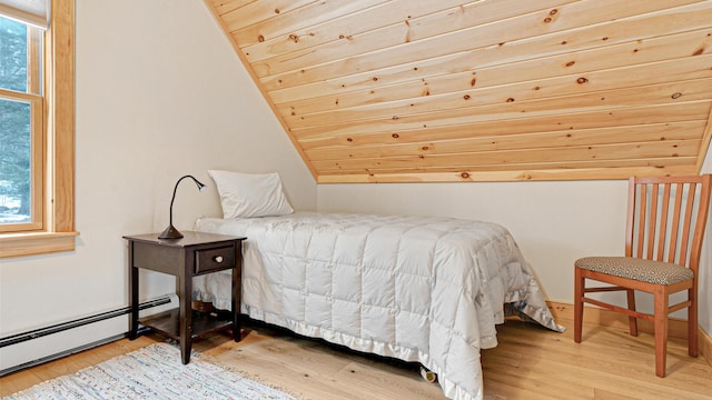 18 Lovers Ln, Bethel, ME 04217 - bedroom with a baseboard radiator, wood finished floors, and vaulted ceiling