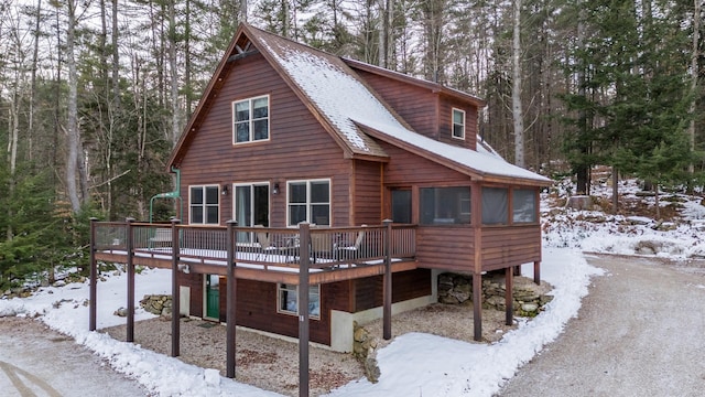 18 Lovers Ln, Bethel, ME 04217 - snow covered rear of property featuring a wooden deck and a sunroom