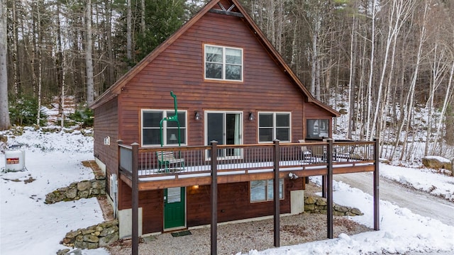 18 Lovers Ln, Bethel, ME 04217 - snow covered back of property with a view of trees and a deck