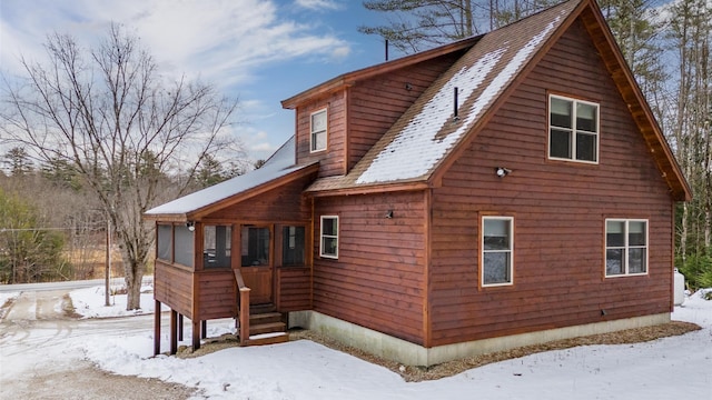 18 Lovers Ln, Bethel, ME 04217 - view of snow covered exterior featuring a shingled roof and a sunroom