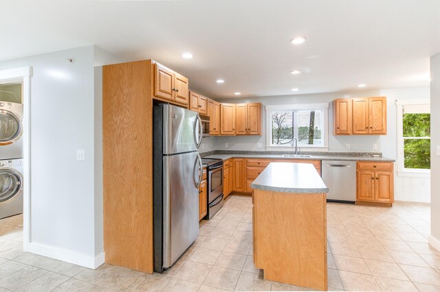 480 E Shore Dr, Acton, ME 04001 - kitchen with a sink, recessed lighting, stacked washing maching and dryer, a kitchen island, and appliances with stainless steel finishes