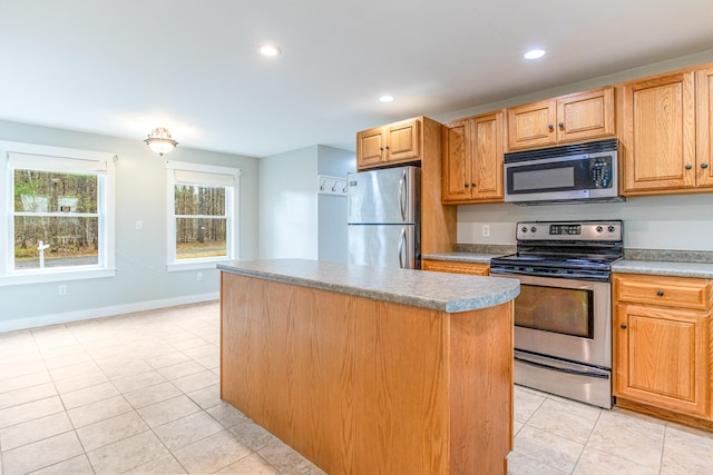 480 E Shore Dr, Acton, ME 04001 - kitchen with baseboards, recessed lighting, light tile patterned floors, a kitchen island, and appliances with stainless steel finishes