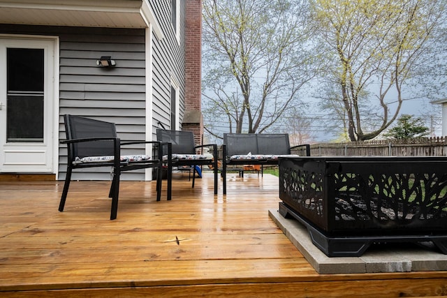 wooden terrace featuring fence