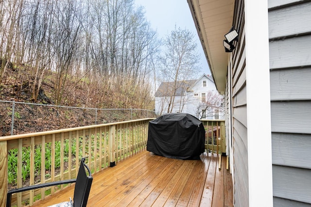 wooden deck with a grill