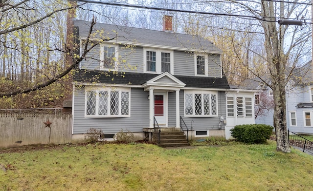 dutch colonial featuring a chimney, entry steps, and roof with shingles