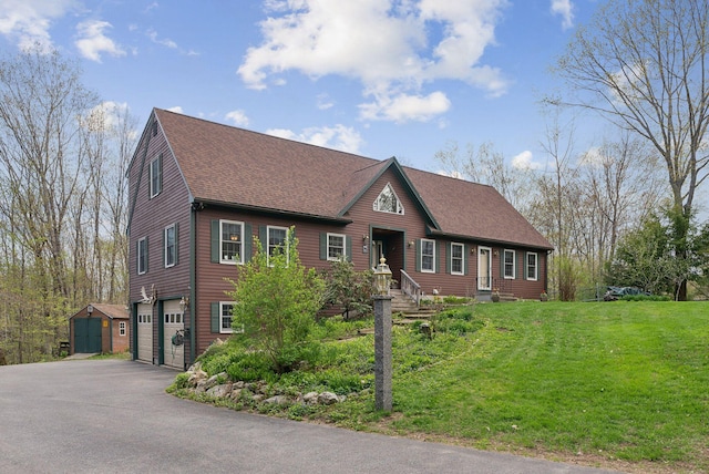 14 Stonebrook Rd, Windham, ME 04062 - view of front of house featuring a garage, a shingled roof, asphalt driveway, a front lawn, and an outdoor structure