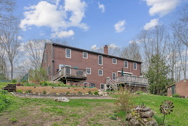 14 Stonebrook Rd, Windham, ME 04062 - back of property with stairs, a wooden deck, a chimney, and a yard