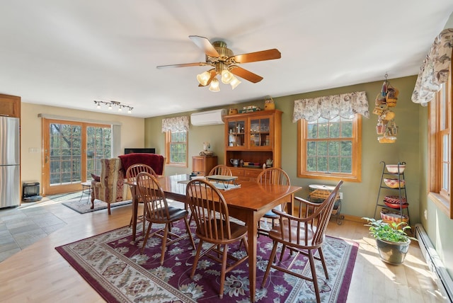 14 Stonebrook Rd, Windham, ME 04062 - dining area featuring baseboard heating, an AC wall unit, a ceiling fan, wood finished floors, and rail lighting