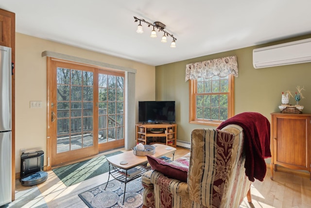 14 Stonebrook Rd, Windham, ME 04062 - living room with a wall unit AC, a baseboard radiator, plenty of natural light, and wood finished floors