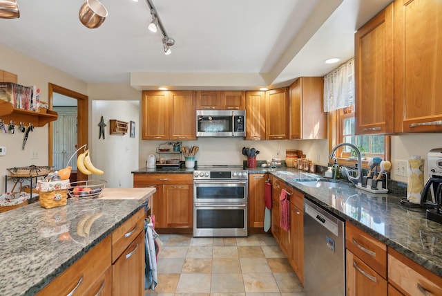 14 Stonebrook Rd, Windham, ME 04062 - kitchen with stainless steel appliances, a sink, dark stone counters, and brown cabinetry