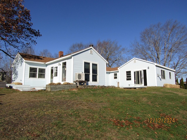 back of house featuring a yard, ac unit, and a chimney