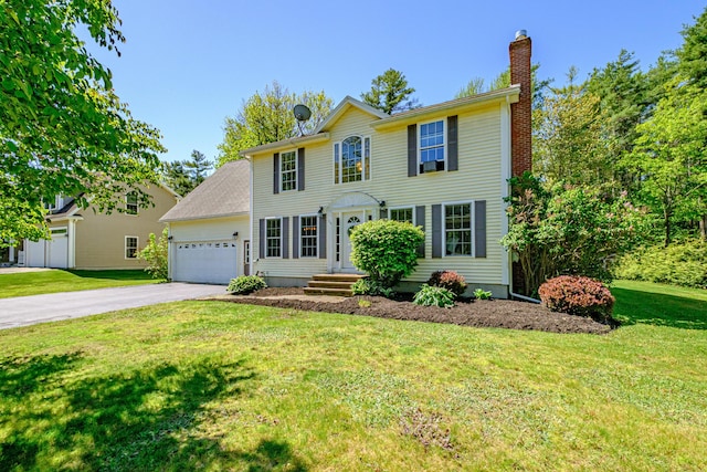 18 Sheila Cir, Saco, ME 04072 - colonial inspired home featuring a chimney, an attached garage, asphalt driveway, and a front lawn