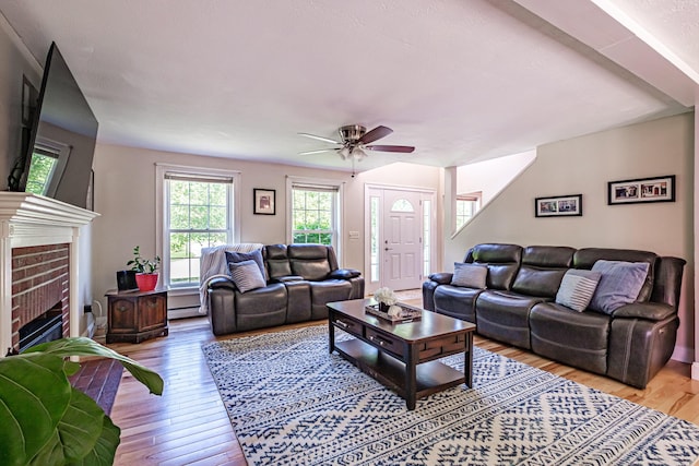 18 Sheila Cir, Saco, ME 04072 - living room featuring hardwood / wood-style flooring, ceiling fan, a baseboard heating unit, and a fireplace