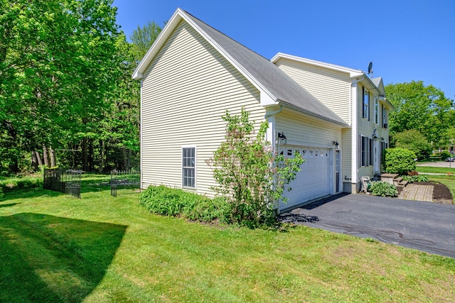 18 Sheila Cir, Saco, ME 04072 - view of side of home with a lawn, driveway, and a garage