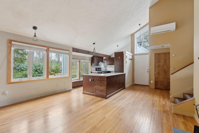 12 Bufflehead Cove Ln, Kennebunk, ME 04043 - kitchen featuring a peninsula, light wood-style flooring, a wealth of natural light, and light countertops