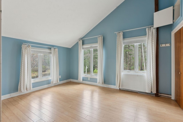 12 Bufflehead Cove Ln, Kennebunk, ME 04043 - empty room with lofted ceiling, baseboards, and wood finished floors