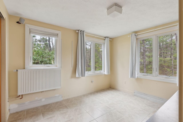 12 Bufflehead Cove Ln, Kennebunk, ME 04043 - unfurnished room featuring radiator and plenty of natural light